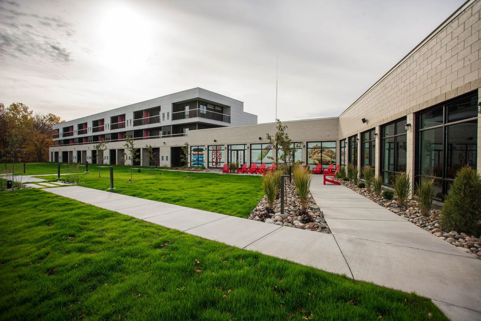 Destination-resort redevelopment — a lakeside resort with a modern guest-room building and landscaped grounds